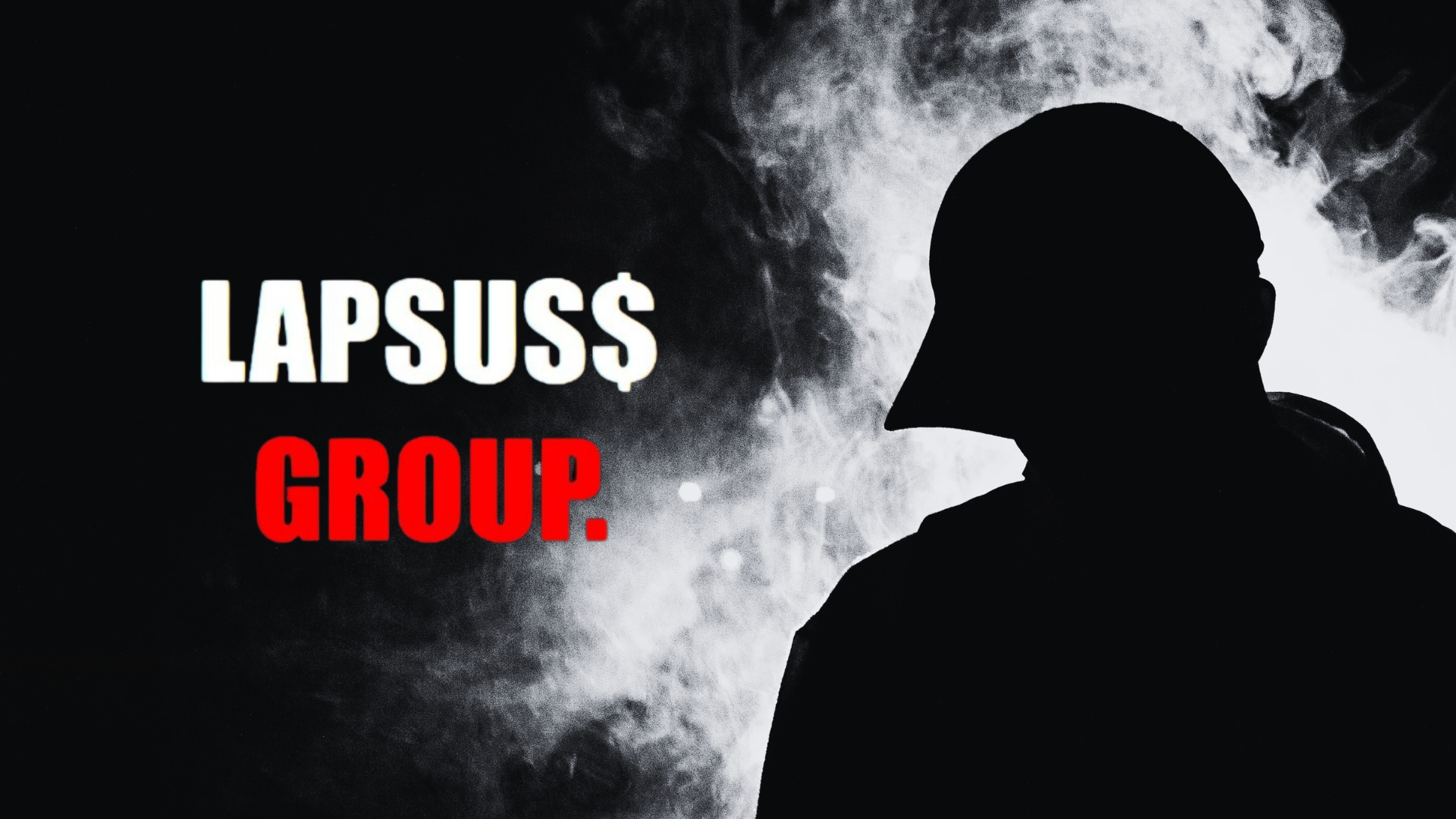 Man standing in the dark with Lapsus$ group logo on the left