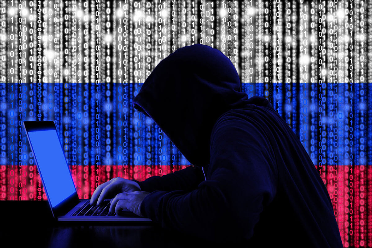 Russian flag made out of binary code and a person hacking into a laptop