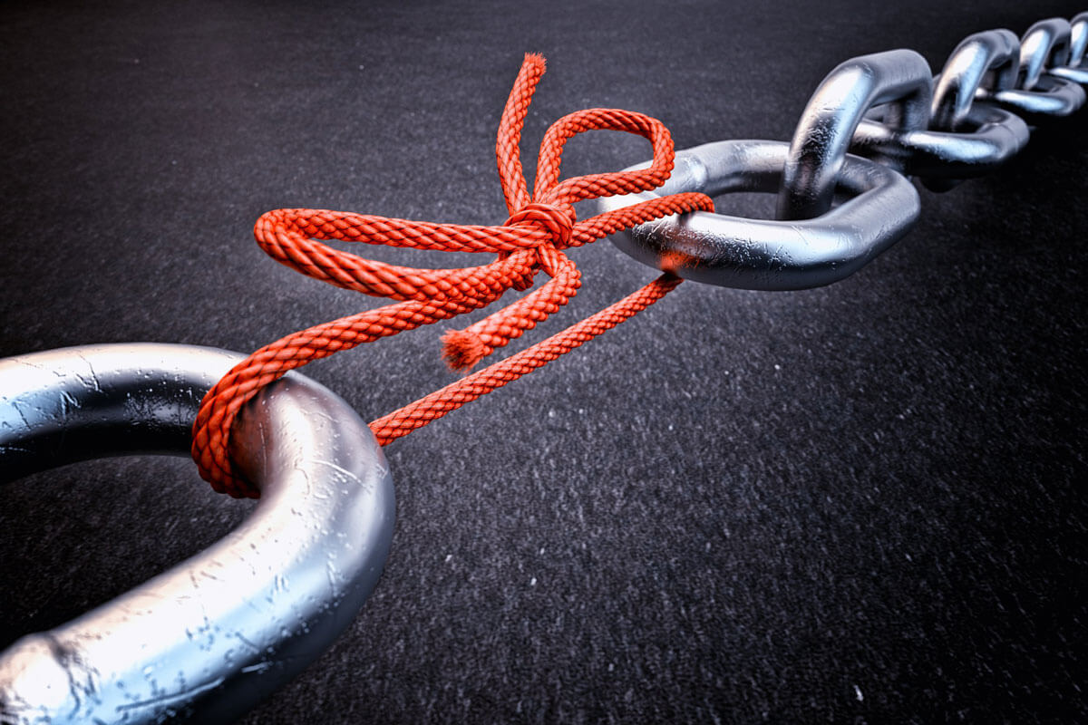 large chain rope being held together with a red cord rope